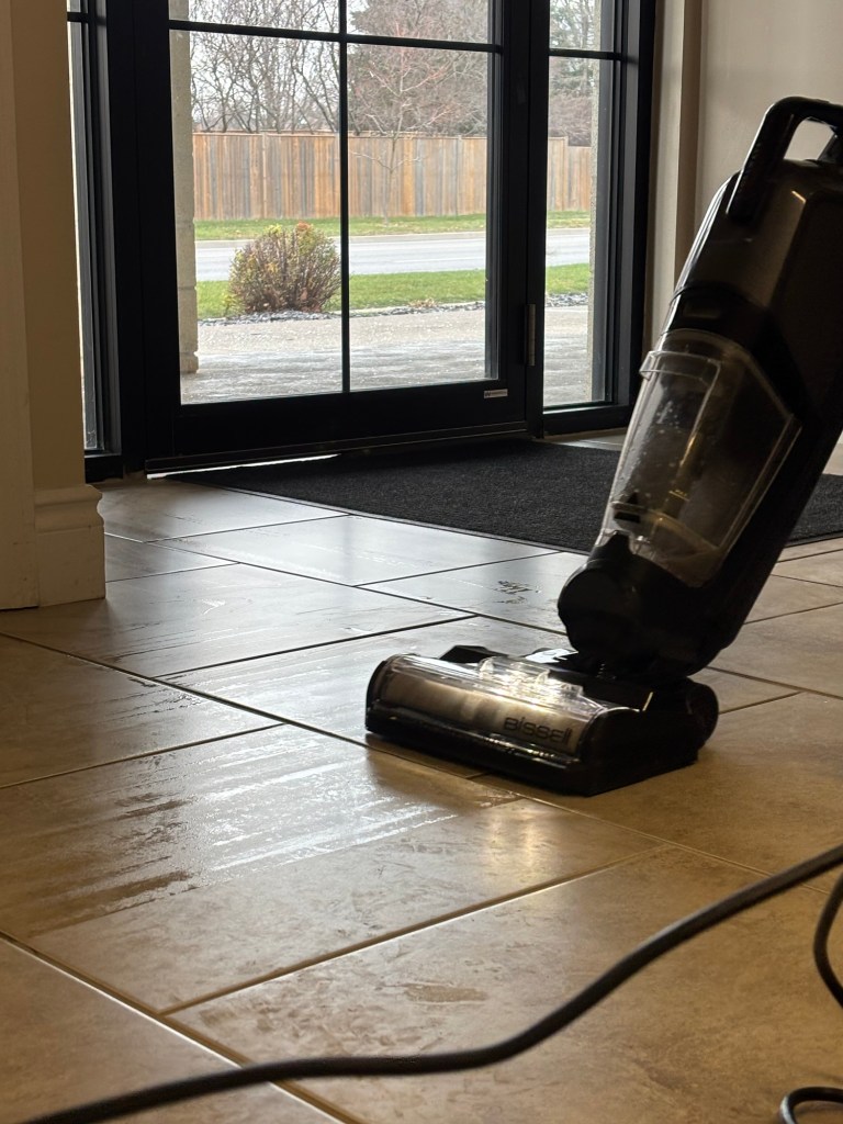 A Bissell Crosswave being used to steam clean a tiled floor
