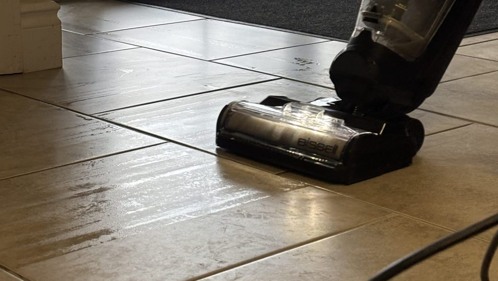 A Bissell Crosswave being used to steam clean a tiled floor