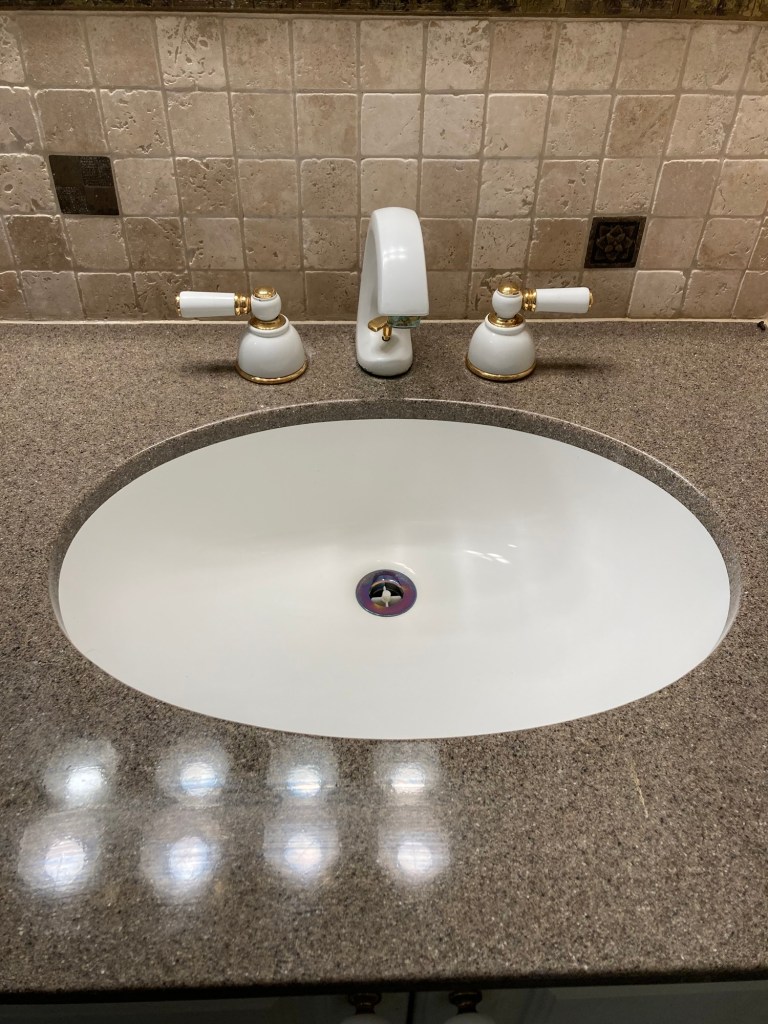 A white bathroom basin looking shiny after cleaning from The Little Mop