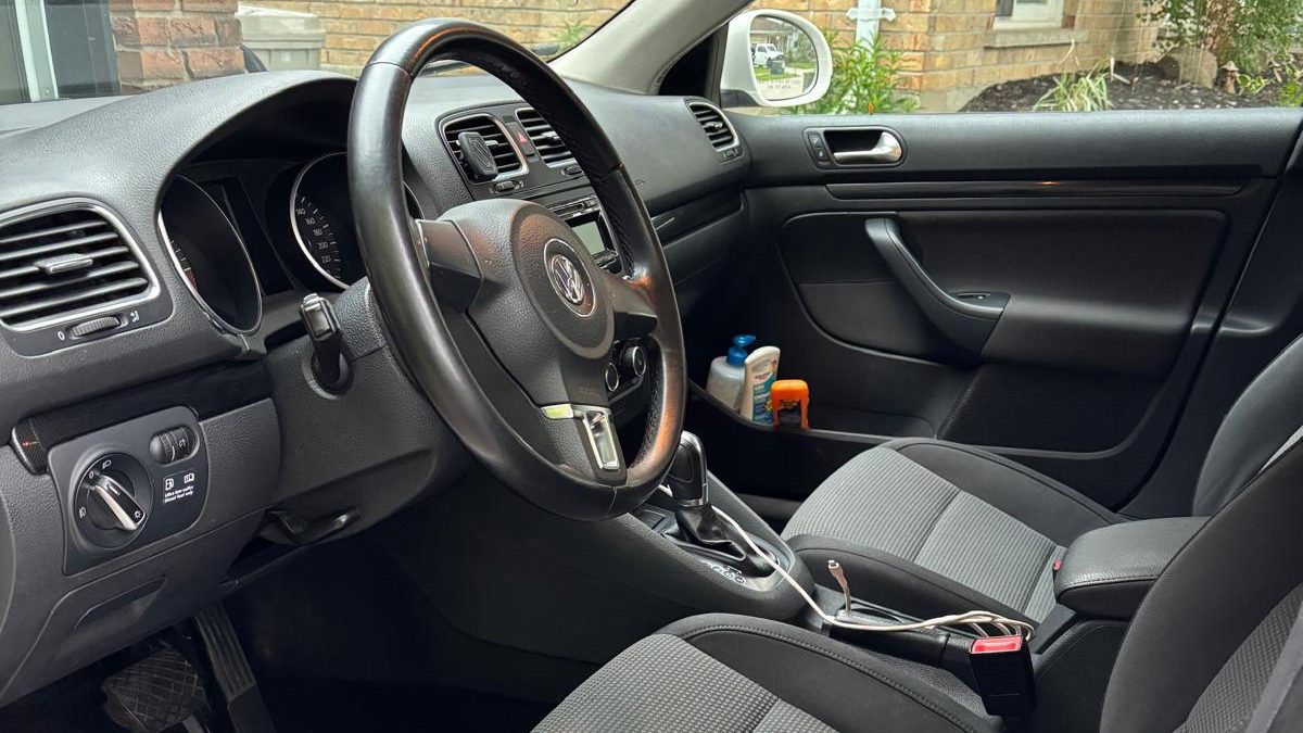 Cropped photo showing the interior of a car after it has been detailed, vacuumed, dusted, wiped down, and carpet cleaned