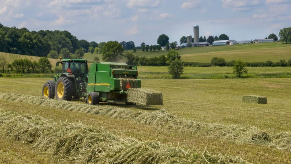 Tractor baling hay in Flamborough field