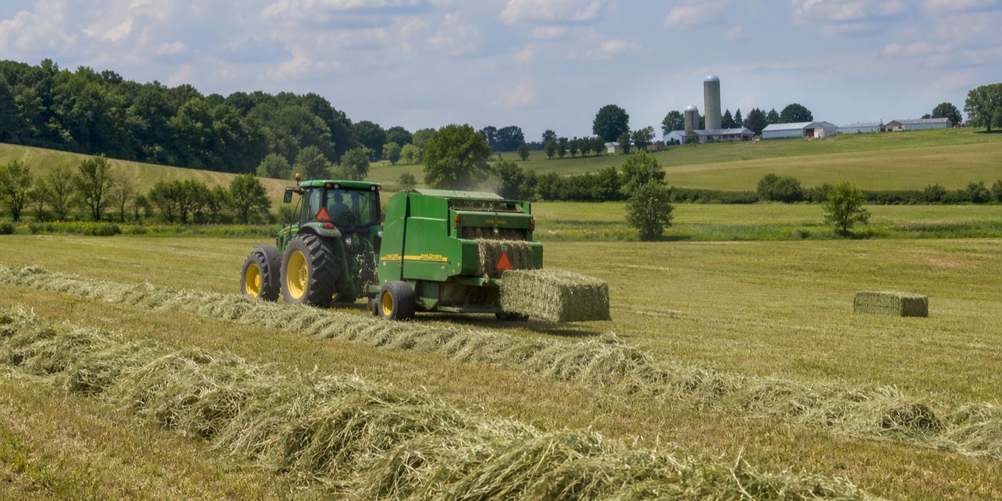 Tractor baling hay in Flamborough field